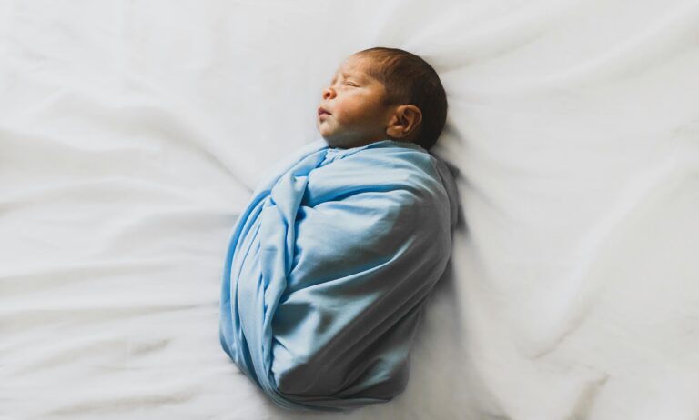 Newborn baby swaddled in a blue blanket | Baby Development at 36 Weeks | Mary's Refuge, Martinsburg WV